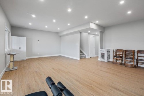 Spacious room featuring light wood-finish flooring, recessed lighting, and light grey wall tones - 45 Elwyck Gate, Spruce Grove, AB 