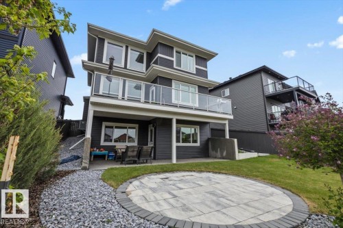 Contemporary multi-level residence featuring dark horizontal siding and prominent white trim - 45 Elwyck Gate, Spruce Grove, AB 