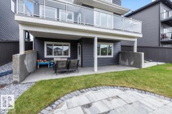 Lower-level patio area featuring a concrete surface and direct access to the back exterior - 