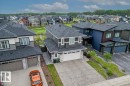 Modern two-story residence featuring a gray and white exterior with stone accents - 45 Elwyck Gate, Spruce Grove, AB 