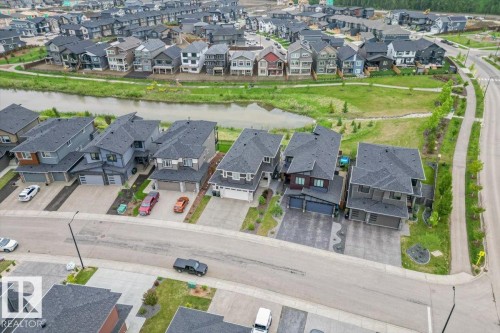Residential street featuring multiple properties with attached garages, paved driveways, and landscaped fronts - 45 Elwyck Gate, Spruce Grove, AB 