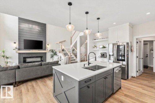 Open-concept living space with wood-finish flooring - 45 Elwyck Gate, Spruce Grove, AB 