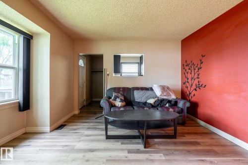 Interior space featuring wood-finish flooring, a neutral color palette, and a textured ceiling - 5919 121 Avenue, Edmonton, AB 
