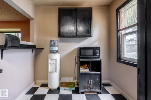 Black and white checkerboard flooring provides a distinct foundation - 5919 121 Avenue, Edmonton, AB 