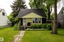 Single-story residence featuring a gabled roof and light yellow siding - 5919 121 Avenue, Edmonton, AB 