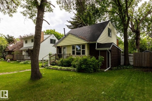 Gable-front home with light yellow siding and a dark shingled roof - 5919 121 Avenue, Edmonton, AB 
