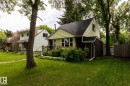 Gable-front home with light yellow siding and a dark shingled roof - 5919 121 Avenue, Edmonton, AB 
