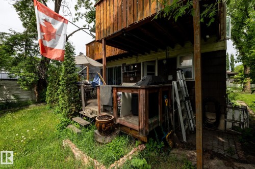 Upper-level wood siding and ground-level dark siding complement the outdoor space - 5919 121 Avenue, Edmonton, AB 