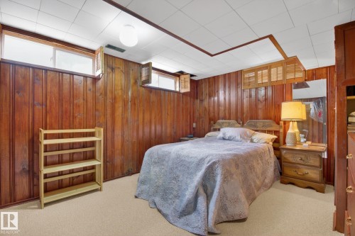 Paneling featuring rich wood tones - 9243 74 Street, Edmonton, AB 