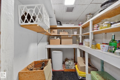 A Cold Storage Room / Utility room featuring extensive built-in shelving, - 9243 74 Street, Edmonton, AB 