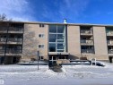Multi-story building featuring a prominent central glass facade - 212 2620 Mill Woods Road E, Edmonton, AB 