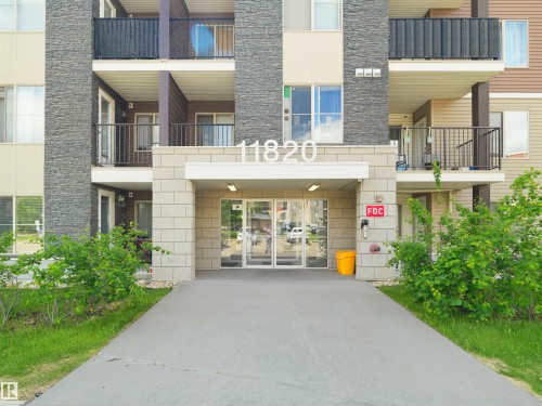Multi-story residential building featuring a stone and siding exterior - 406 11820 22 Avenue, Edmonton, AB 