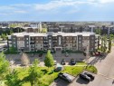 Modern multi-story residential building featuring a neutral color palette - 406 11820 22 Avenue, Edmonton, AB 