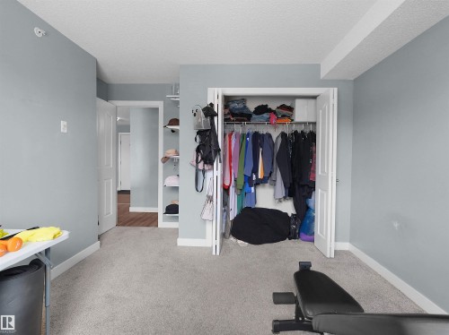 Built-in closet with bi-fold doors - 406 11820 22 Avenue, Edmonton, AB 