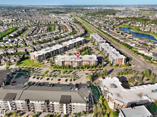 Aerial perspective showcasing a multi-story residential building with private balconies and surface parking - 406 11820 22 Avenue, Edmonton, AB 
