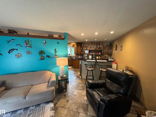 Open-concept living space featuring tile flooring throughout - 4502 55 Avenue, Vegreville, AB 