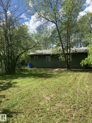 Single-story residence featuring green siding and a light-colored roof - #446 67432 Mcgrane Rd, Rural Lac La Biche County, AB 