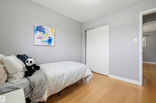 Light wood-finish flooring complements the neutral wall color - 10712 52 Avenue, Edmonton, AB 