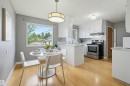 Open-concept kitchen and dining area featuring light wood-finish flooring - 10712 52 Avenue, Edmonton, AB 