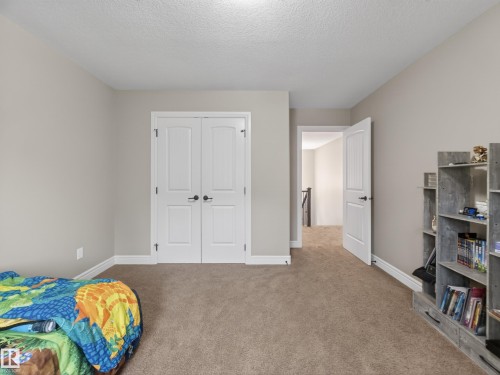 Neutral wall color complemented by broadloom carpeting - 5608 Soleil Boulevard, Beaumont, AB 
