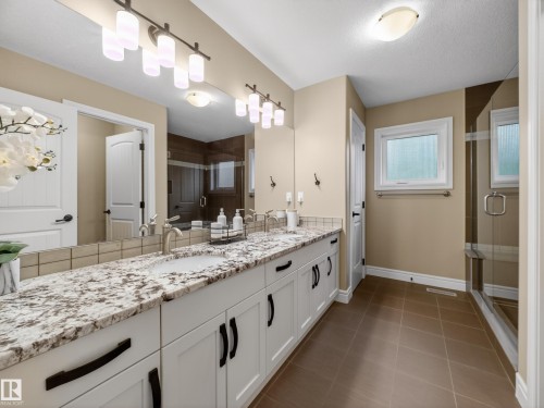 Double vanity with granite countertop, undermount sinks, and brushed nickel fixtures - 5608 Soleil Boulevard, Beaumont, AB 