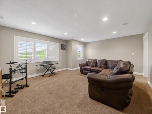 Carpeted room with recessed lighting and a window featuring plantation shutters - 5608 Soleil Boulevard, Beaumont, AB 