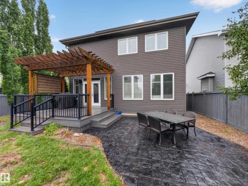 Back exterior featuring a two-story design with horizontal siding and multiple windows - 5608 Soleil Boulevard, Beaumont, AB 