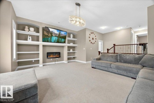 Spacious living area featuring light-toned carpeting and neutral wall tones - 1326 Cunningham Drive, Edmonton, AB 