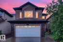 Two-story stucco facade featuring stone veneer accents - 1326 Cunningham Drive, Edmonton, AB 