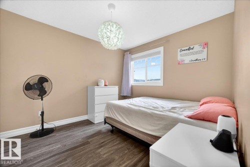 Room featuring wood-finish flooring, neutral wall paint, and white trim - 1326 Cunningham Drive, Edmonton, AB 