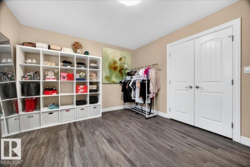 Wide plank wood-finish flooring with white baseboards - 1326 Cunningham Drive, Edmonton, AB 