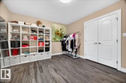 Wide plank wood-finish flooring with white baseboards - 