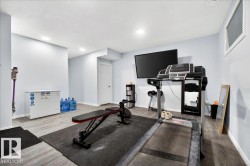 Versatile bonus room featuring wood-finish flooring and light blue walls - 