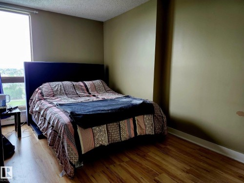 Room with wood-finish flooring, neutral wall tones, and white trim - 1600 10149 Saskatchewan Drive, Edmonton, AB 