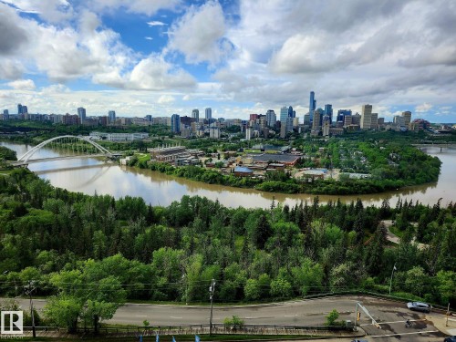 Expansive cityscape featuring a riverbend, a prominent arch bridge, and dense green tree cover - 1600 10149 Saskatchewan Drive, Edmonton, AB 