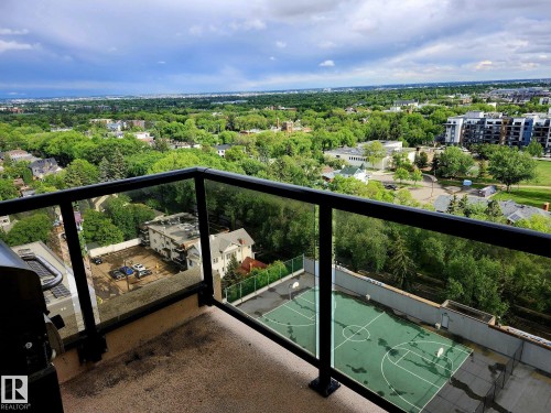Private balcony with glass panel railing and cityscape backdrop - 1600 10149 Saskatchewan Drive, Edmonton, AB 