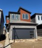 Contemporary exterior featuring multi-toned siding and brick veneer accents - 2206 Crossbill Link, Edmonton, AB 