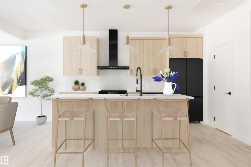 Kitchen island featuring a dark countertop with an undermount sink and matte black faucet - 2206 Crossbill Link, Edmonton, AB 