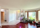 Entryway featuring a ceramic tile floor, double bi-fold coat closet doors, and a lot of natural lights. - 825 112B St, Edmonton, AB 