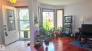 Entryway featuring a decorative glass paneled door, ceramic tile flooring, and a luminous ceiling fixture. - 825 112B St, Edmonton, AB 