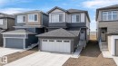 Modern two-story residence featuring a multi-tone exterior siding, an attached double garage with white panel doors, and a concrete driveway - 8108 230 Street, Edmonton, AB 