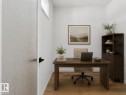 Private workspace featuring wood-finish flooring, white walls, and a high transom window - 8108 230 Street, Edmonton, AB 
