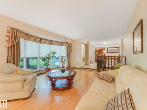 Living area featuring light wood-finish flooring and a prominent bay window - 11921 231 Street, Edmonton, AB 