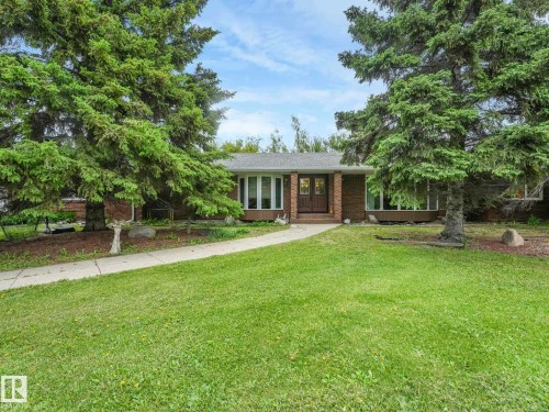 Brick exterior residence with a contrasting roofline, dual entry doors, and multiple large windows - 11921 231 Street, Edmonton, AB 