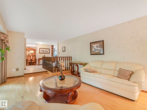 Living area featuring light wood-finish flooring and textured light-toned walls - 11921 231 Street, Edmonton, AB 