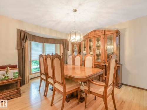 Light wood-finish flooring complements the neutral wall tones - 11921 231 Street, Edmonton, AB 
