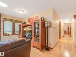 Living area featuring light wood-finish flooring, neutral wall tones, and recessed lighting - 