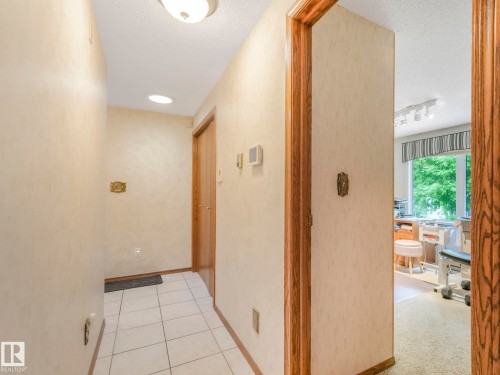 Entrance hall featuring white tile flooring, recessed lighting, and a flush mount ceiling fixture - 11921 231 Street, Edmonton, AB 