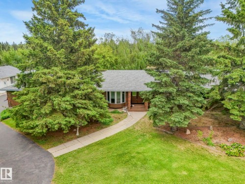 Ranch-style residence featuring a brick facade and a gray shingle roof - 11921 231 Street, Edmonton, AB 