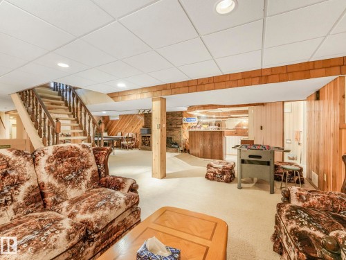 Finished basement with neutral carpet flooring and a drop ceiling with recessed lighting - 11921 231 Street, Edmonton, AB 
